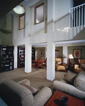 A living room with a couch, chairs, and a coffee table.