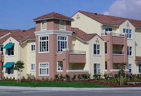 A row of houses with balconies and awnings.