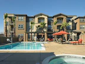 A large apartment complex with a pool and patio area.