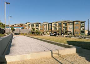 A row of apartment buildings with a clear blue sky above.