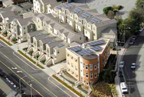 Apartment buildings with solar panels on the roofs.