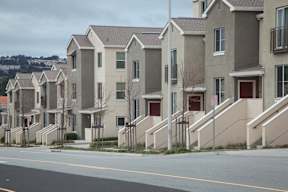 A row of houses with a road in front.