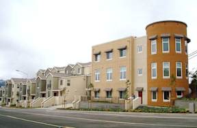 A row of houses with a mix of beige and brown colors.