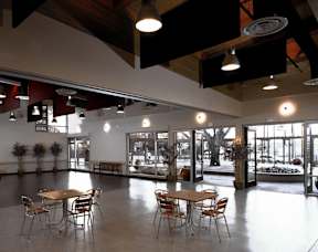 A large room with tables and chairs and a view of the outside.