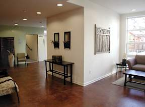 A living room with a brown table and chairs.