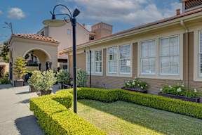 A house with a well-manicured lawn and a street lamp.