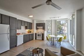 A modern kitchen with a dining table and chairs.