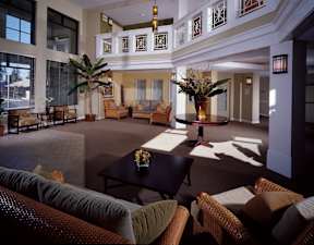A large room with a lot of brown furniture.