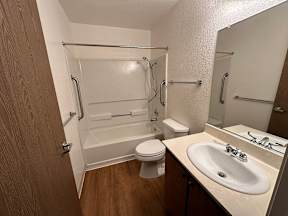 A bathroom with a toilet, sink, and bathtub.