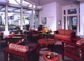 A living room with a brown sofa and a coffee table.