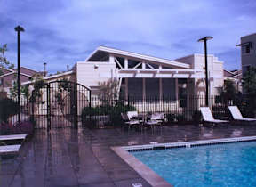 A pool area with a building in the background.