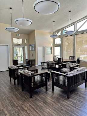 A room with a long table and chairs.