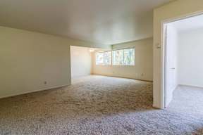 A room with a carpeted floor and a window with blinds.at Terra Linda Manor, California