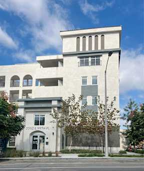 A white building with a black door and windows.