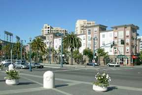 A city street with cars and buildings in the background.