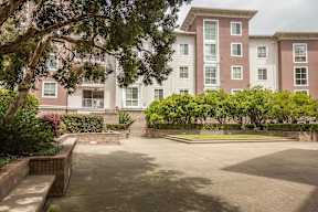 A large building with a courtyard in front of it.