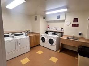 A laundry room with washers and dryers.
