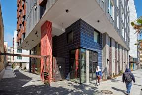 A modern building with a red and blue tiled facade.