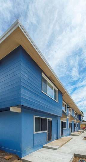 A blue building with a white roof and windows.