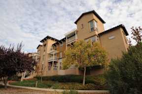 A large apartment building with a balcony on the second floor.