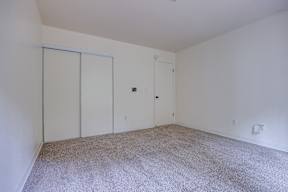 A room with carpeted floor and white walls.