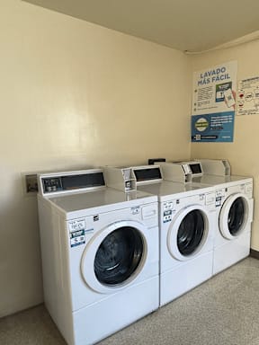 A row of washing machines in a laundromat.