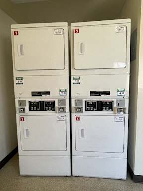 Two identical washing machines are stacked on top of each other.