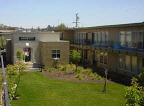A building with a green lawn in front of it.
