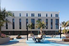 A modern building with a pool in front.