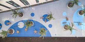 A wall with blue circles and palm trees.