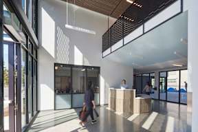 A reception area with a person walking by.