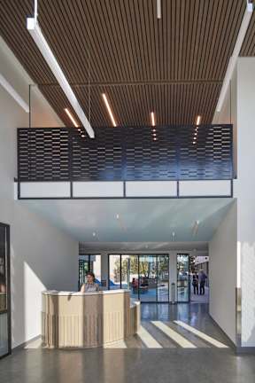 A reception area with a person sitting behind the desk.