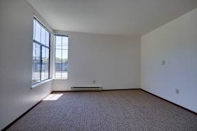 A room with a carpet floor and a window.