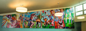 A wall of paintings depicting people in various poses.