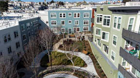 A view of a courtyard between two apartment buildings.
