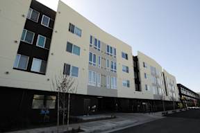 A row of modern buildings with large windows.