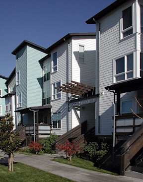 Apartment buildings with staircases leading to the second floor.
