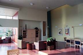 A living room with a couch, chairs, and a table.