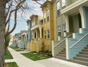 A row of houses with blue and green painted exteriors.