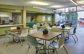 A modern office space with tables and chairs.