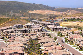A suburban neighborhood with houses and a road.