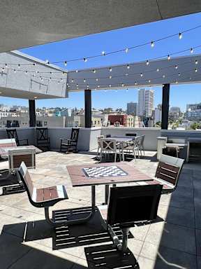 A rooftop patio with a chess board in the middle.
