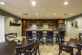 A dining room with a table set for four.