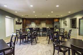 A dining room with a table set for six.