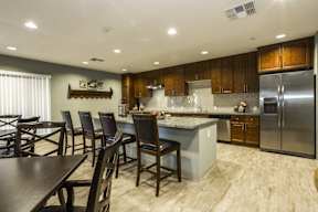 A modern kitchen with wooden cabinets and a center island.