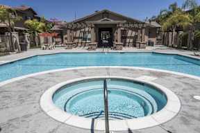 A round pool with a hot tub in the middle.