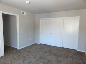 A room with white walls and carpeted floor.