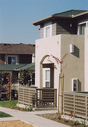 A house with a green lawn and a fence.