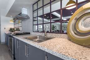 A modern kitchen with a large island and a stainless steel sink.