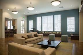 A living room with a couch, ottoman, and coffee table.